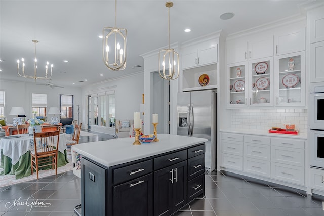 kitchen with light countertops, glass insert cabinets, white cabinetry, dark cabinets, and stainless steel fridge with ice dispenser