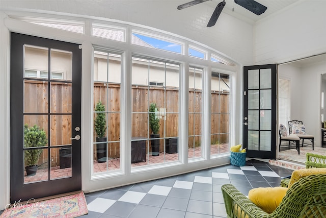 sunroom / solarium featuring a ceiling fan