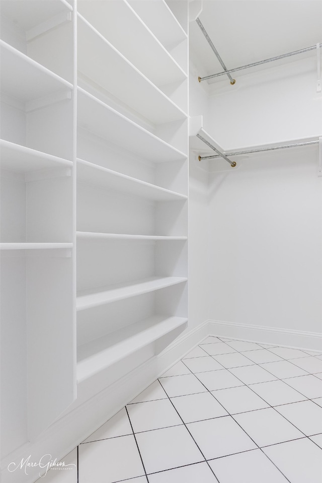 spacious closet with tile patterned floors