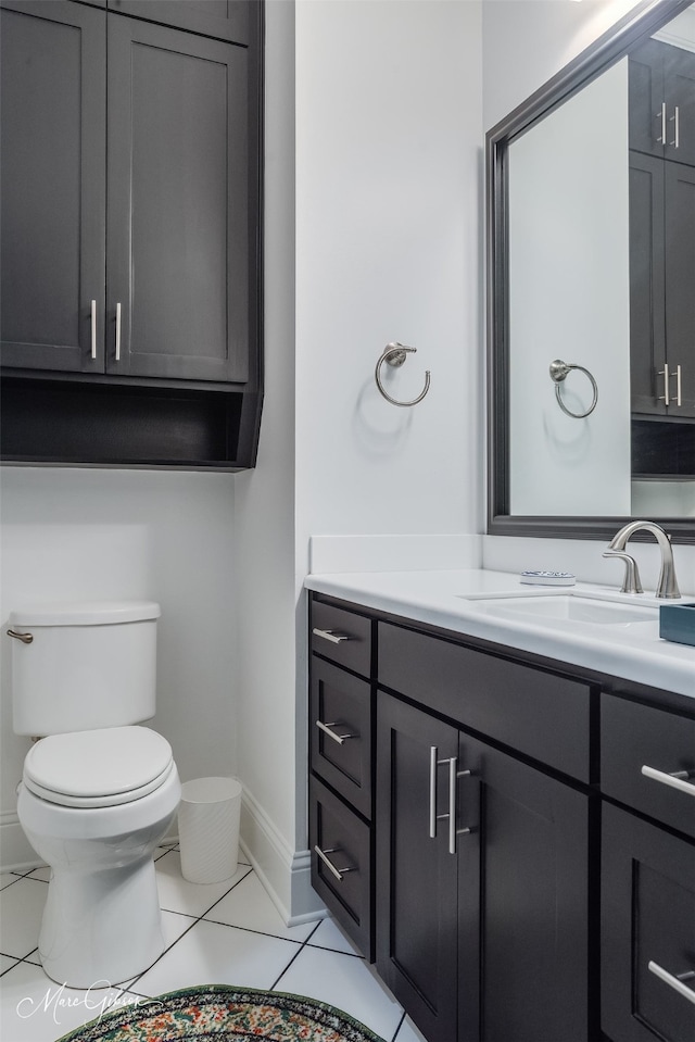 half bath with toilet, vanity, and baseboards