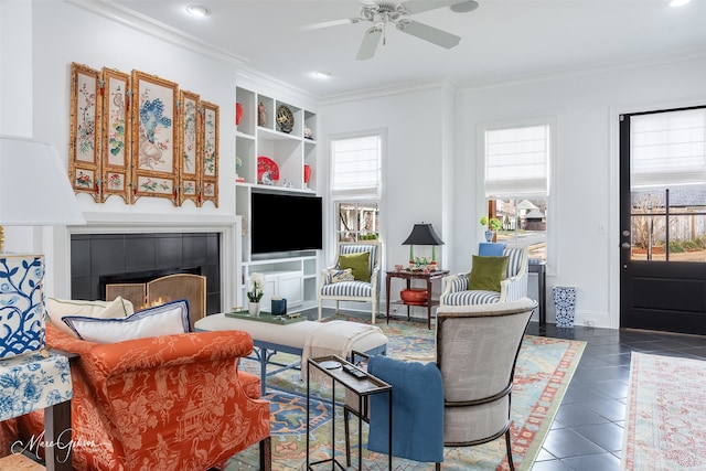 living area featuring ornamental molding, a wealth of natural light, and dark tile patterned floors