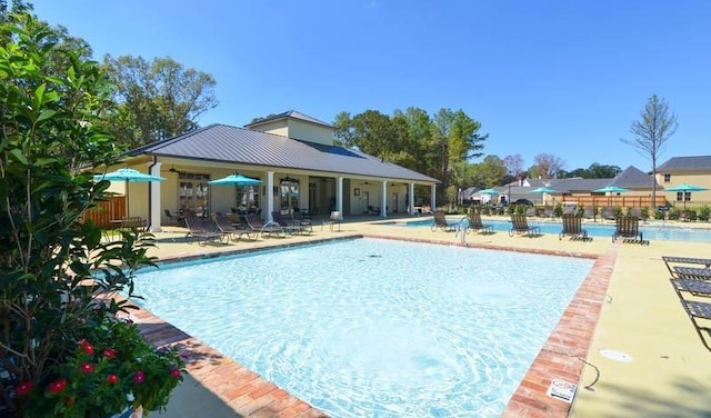 pool featuring fence and a patio