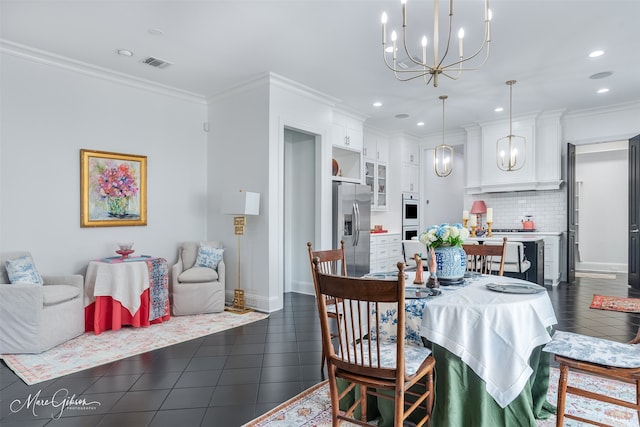 dining area with a notable chandelier, dark tile patterned flooring, visible vents, and crown molding