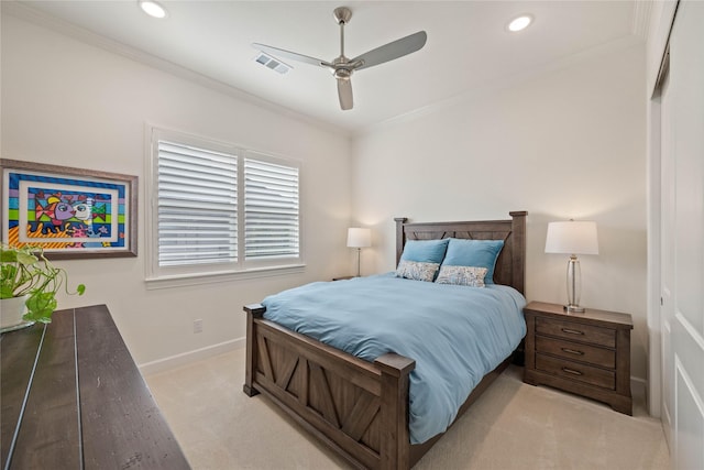 bedroom featuring baseboards, ornamental molding, visible vents, and light colored carpet