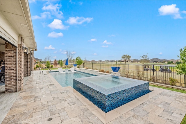 view of swimming pool with a patio, a fenced backyard, and a pool with connected hot tub