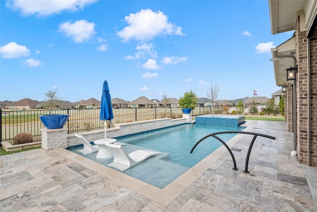 view of swimming pool featuring a patio area, a fenced backyard, and a residential view