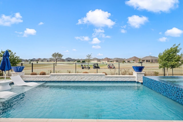 view of swimming pool featuring fence, a residential view, and a fenced in pool