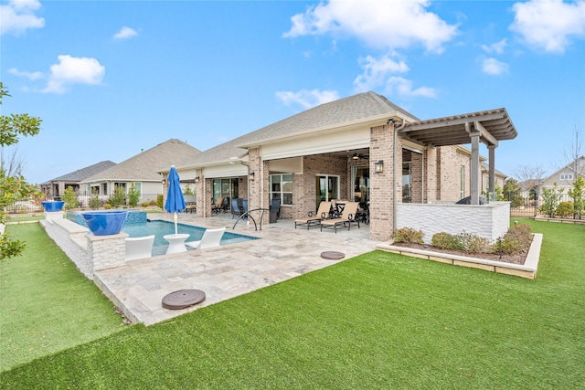 back of property with an outdoor pool, a ceiling fan, a patio, fence, and brick siding