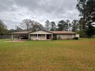 rear view of house with a lawn