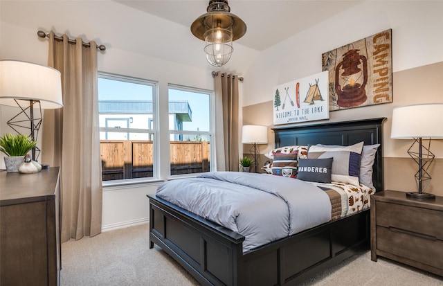 bedroom with light carpet and baseboards