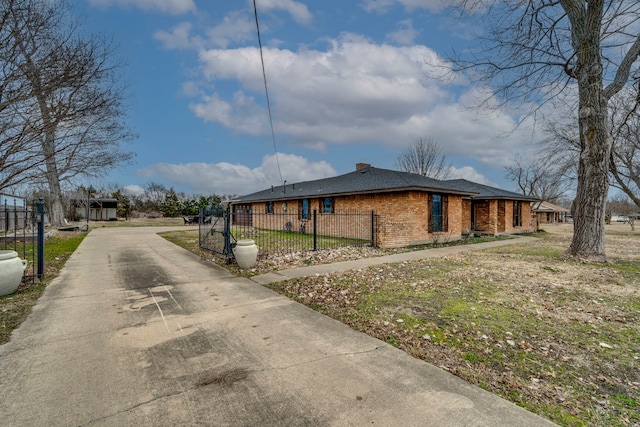 view of property exterior featuring a fenced front yard and brick siding