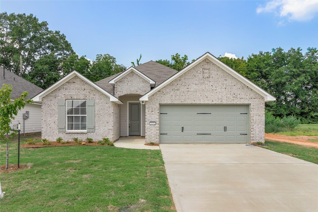 3371 Grand Lake Dr, Bossier City, LA 71111 - single story home with a garage, driveway, a front lawn, and brick siding