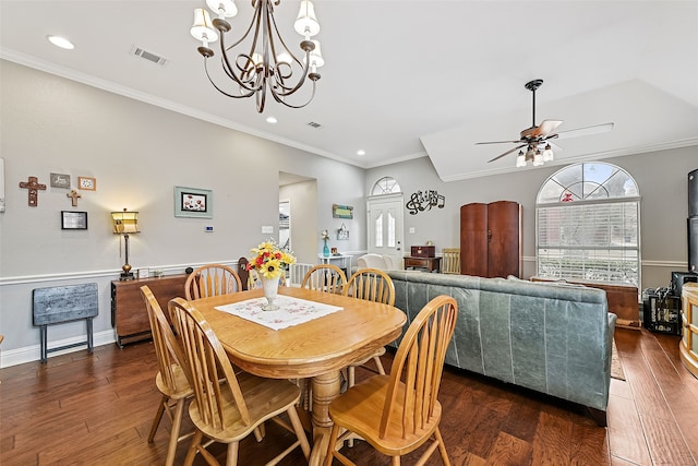 dining room featuring visible vents, ornamental molding, dark wood-style floors, and a wood stove