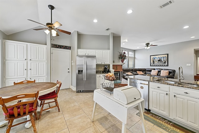 kitchen with visible vents, white cabinets, appliances with stainless steel finishes, open floor plan, and a sink