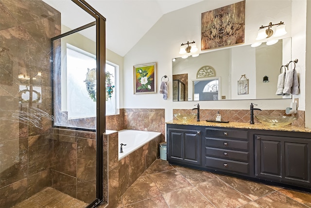 full bathroom featuring lofted ceiling, a garden tub, double vanity, and a stall shower