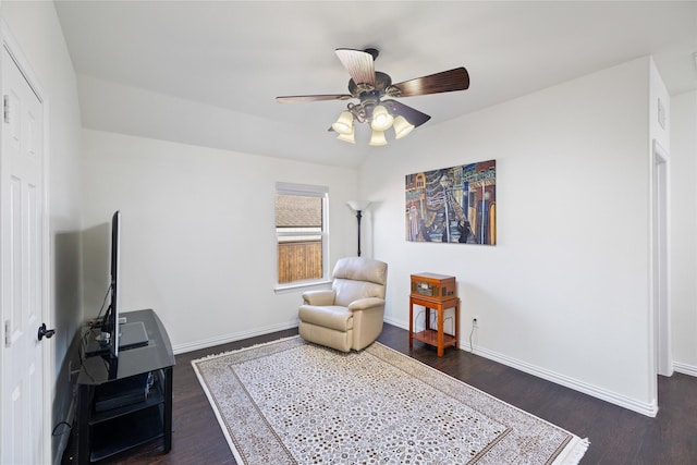 sitting room with a ceiling fan, lofted ceiling, dark wood-style flooring, and baseboards