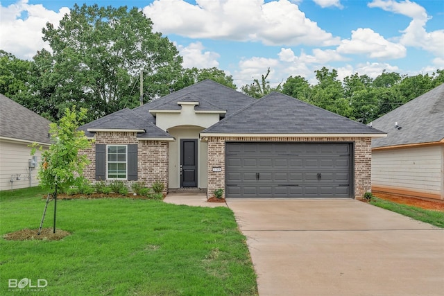 view of front facade featuring driveway, a front yard, a garage, and brick siding