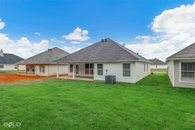 back of property featuring roof with shingles, a patio area, a yard, and central air condition unit