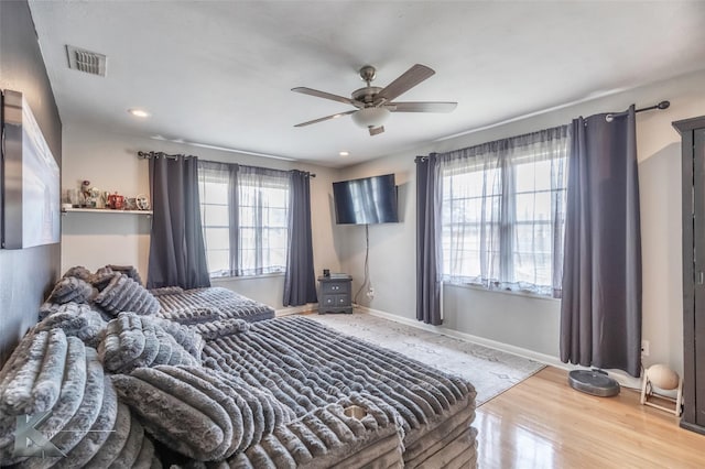 bedroom featuring recessed lighting, wood finished floors, a ceiling fan, visible vents, and baseboards