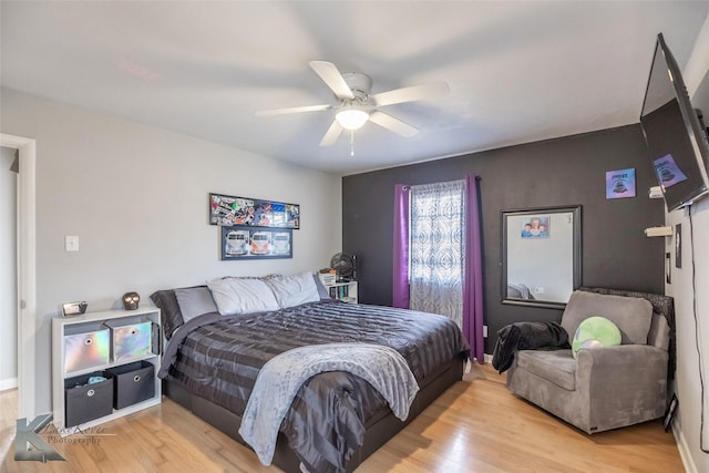 bedroom with light wood-type flooring and ceiling fan