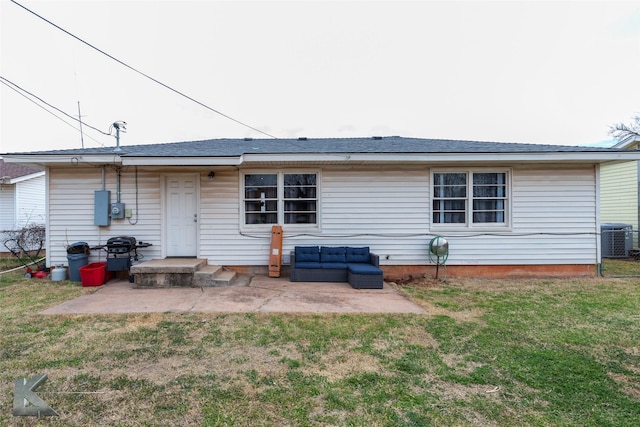 rear view of property featuring a patio area, an outdoor living space, central AC, and a yard