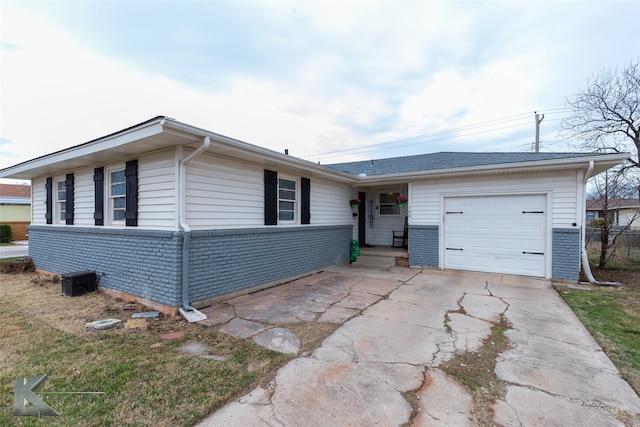 ranch-style house with a garage, concrete driveway, and brick siding