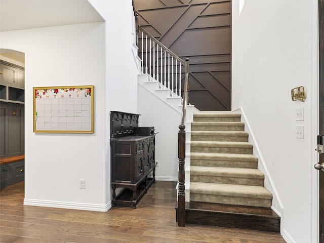 stairs featuring baseboards and wood finished floors