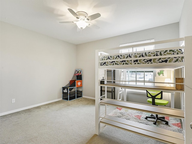 office space with carpet floors, a ceiling fan, and baseboards