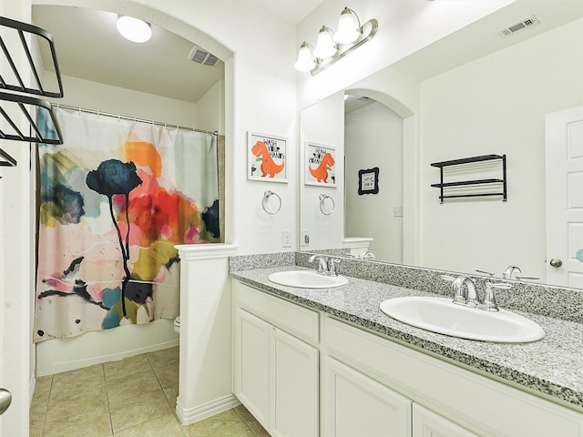 bathroom featuring shower / bath combination with curtain, visible vents, a sink, and toilet