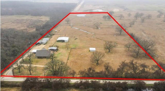 birds eye view of property with a rural view