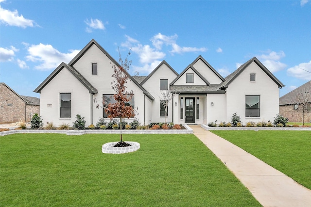 modern farmhouse with roof with shingles and a front lawn