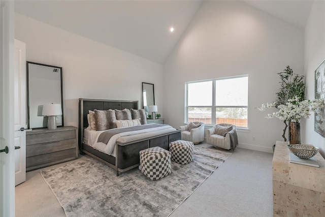 bedroom with light carpet, high vaulted ceiling, and baseboards