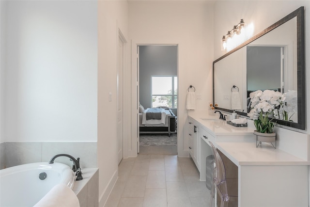 ensuite bathroom with tile patterned flooring, vanity, a bath, and ensuite bathroom