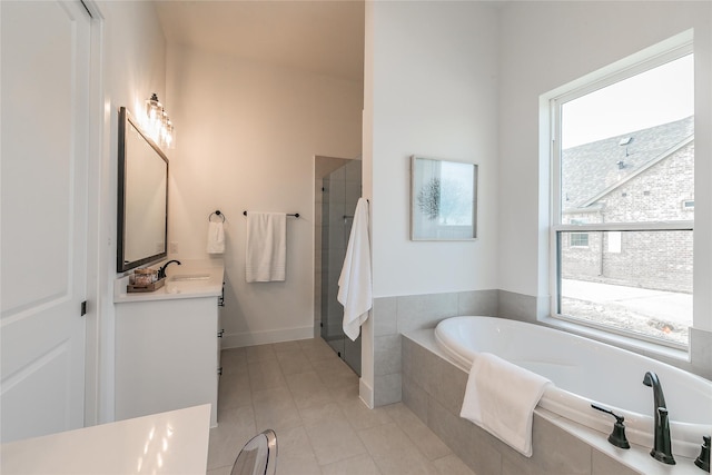 full bathroom with a bath, a shower stall, vanity, and tile patterned floors