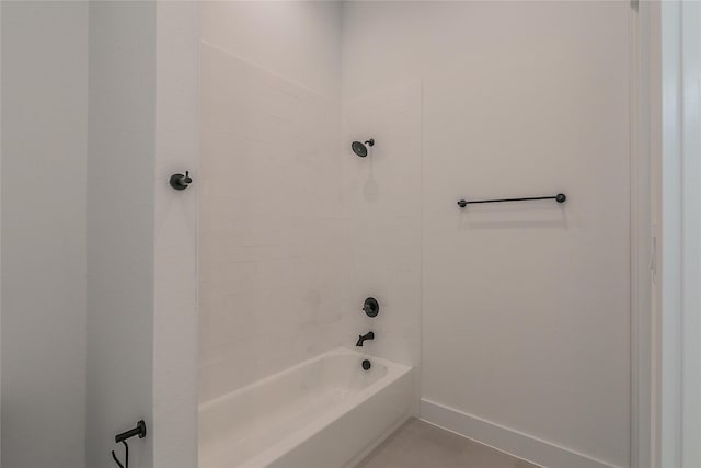 full bathroom with bathtub / shower combination and baseboards