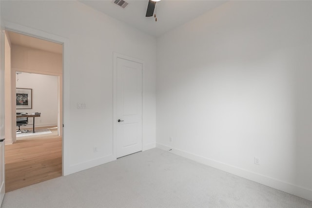 unfurnished bedroom featuring carpet, visible vents, ceiling fan, and baseboards