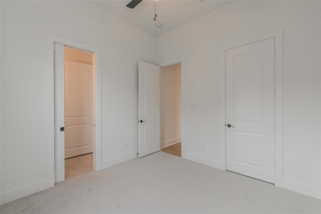 unfurnished bedroom with light carpet and baseboards