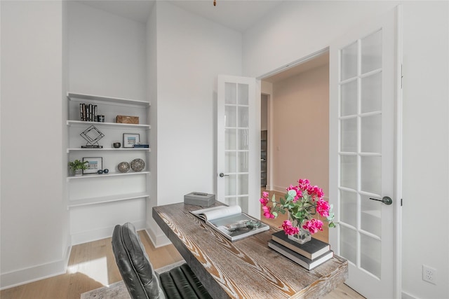 office area featuring french doors, light wood-type flooring, and baseboards