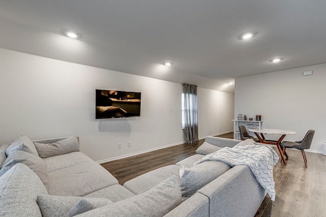 living room with baseboards, dark wood finished floors, and recessed lighting