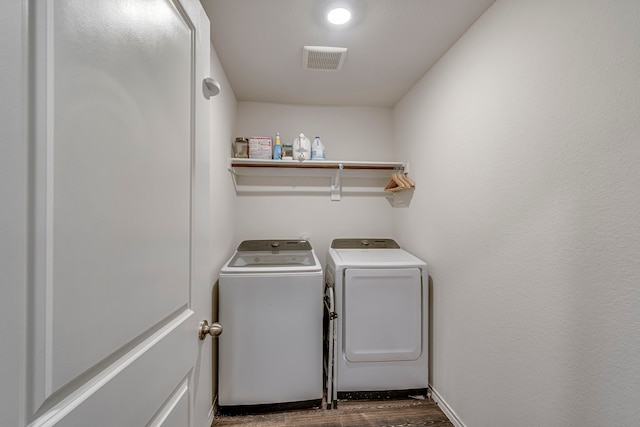 laundry area featuring laundry area, visible vents, independent washer and dryer, and dark wood-style flooring