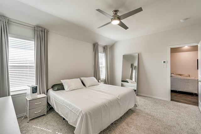 bedroom featuring carpet, vaulted ceiling, baseboards, and ceiling fan