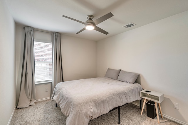 bedroom with light carpet, baseboards, visible vents, and ceiling fan