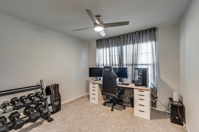 home office featuring light colored carpet, ceiling fan, and baseboards