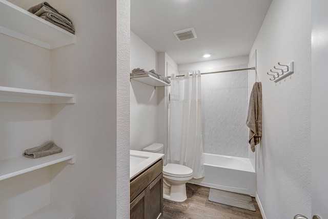 bathroom with visible vents, toilet, wood finished floors, shower / bathtub combination with curtain, and vanity