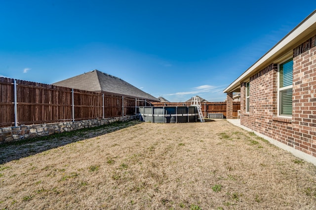 view of yard with a fenced backyard and a fenced in pool