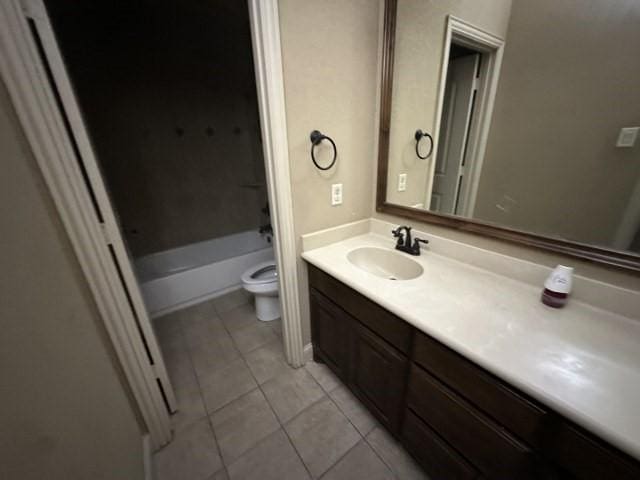 full bathroom featuring toilet, tile patterned flooring, shower / washtub combination, and vanity