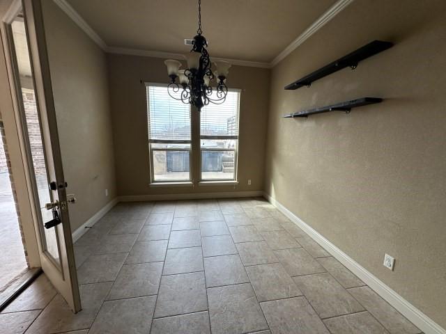 unfurnished dining area with ornamental molding, a notable chandelier, and baseboards