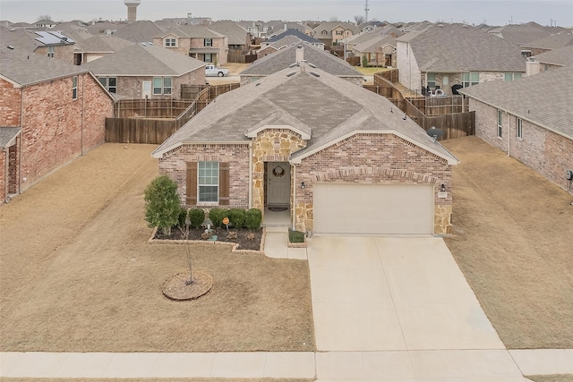 french country inspired facade with driveway, a residential view, fence, and brick siding