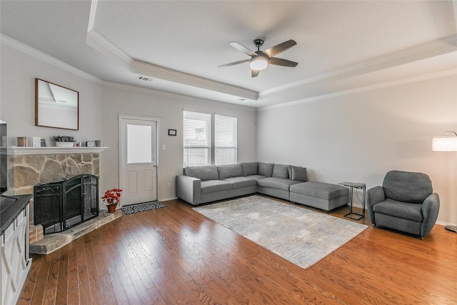 537 Running Water Trl, Fort Worth, TX 76131 - living area with a raised ceiling, a ceiling fan, a fireplace, hardwood / wood-style floors, and crown molding