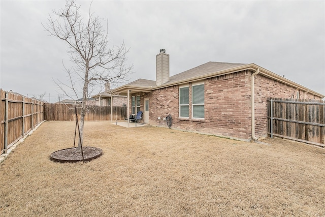 537 Running Water Trl, Fort Worth, TX 76131 - rear view of property with a chimney, brick siding, a fenced backyard, and a patio area